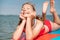 Happy teen girl lying on SUP board and enjoy water