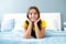 Happy teen girl, positive and smiling emotions. Teenager child girl daydreaming in bed, dreaming kids concept.