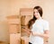 Happy teen girl with tablet computer standing on a background of cardboard