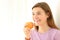 Happy teen holding an apple looking away