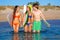 Happy teen surfers talking on beach shore