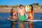 Happy teen surfers talking on beach shore