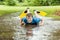 Happy teen trying to swim in muddy puddle