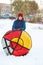 Happy teenage boy sliding down hill on snow tube Snow tubing on winter day outdoors. Winter activity, active leisure and entertain