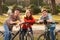 Happy teenage boys and girl having fun on bicycles