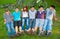 Happy teenage boys and girls resting in the grass