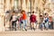 Happy teenage boys and girls rollerblading in city