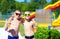 Happy teenage boys showing thumbs up in water park