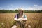Happy Teenage Farm Girl in Wheat Field