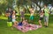 Happy teenage friends enjoying a picnic outdoors