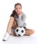 Happy teenage girl football player sits with ball