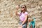 Happy teenage girl with longboard and smartphone