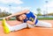 Happy teenage girl making yoga stretching outside