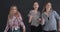 Happy teenage girls dancing against studio background