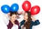 Happy teenage girls with helium balloons