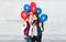 Happy teenage girls with helium balloons
