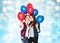 Happy teenage girls with helium balloons