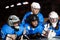 Happy teenage hockey players laying on ice rink