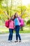 Happy teenage schoolgirls with schoolbag