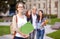 Happy teenage students with school folders