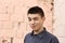 Happy teenager boy wink closeup portrait on white wall background