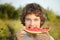 Happy teenager eating watermelon