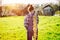 Happy Teenager girl in summer yellow boxing field. Girl farmer preparing for planting bulbs. Bouquet of onions in the