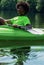 Happy teenager kayaks on scenic river