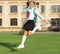 Happy teenager in school uniform jumping midair. Energetic teenage girl carrying school bag