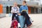 Happy teenagers schoolboy and schoolgirl sitting on schoolyard and joyful talking