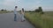 Happy teens having joyful talk during a walk with skateboard out of city