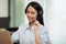 Happy Telemarketer Asian woman wear headset smile and customer support