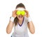 Happy tennis player holding balls in front of eyes