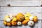 Happy Thanksgiving Background. Selection of various pumpkins on white wooden background. Autumn vegetables and seasonal decoration