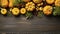 Happy Thanksgiving concept. Composition with ripe orange pumpkins, fallen leaves, dry flowers on rustic wooden table