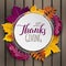 Happy Thanksgiving greeting card. Autumn floral paper frame and paper colorful tree leaves on wooden background