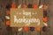 Happy Thanksgiving greeting card with frame of wooden autumn leaves