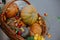 Happy Thanksgiving and Halloween. Pumpkins, autumn vegetables and flowers in wicker basket, rustic festive decoration of european