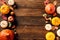 Happy Thanksgiving holiday background. Flat lay, top view pumpkins, apple, red berries, fall leaves, walnuts on wooden desk table