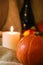 Happy Thanksgiving post card. Autumn holidays still life. Halloween orange pumpkin with soft candle light on sackcloth