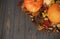 Happy Thanksgiving. Pumpkins, autumn leaves, anise, acorns, cinnamon border on rustic dark wood with space for text. Hello Autumn