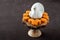 Happy Thanksgiving, small pumpkin cakes, white ceramic turkey on a wooden cake stand, brown background