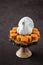 Happy Thanksgiving, small pumpkin cakes, white ceramic turkey on a wooden cake stand, brown background