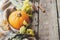 Happy Thanksgiving. Stylish pumpkin, autumn leaves, flowers and cozy blanket on rustic old wooden background. Rural fall layout