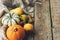 Happy Thanksgiving. Stylish pumpkins, autumn leaves, pears and cozy scarf on rustic old wooden background. Rural fall composition