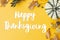 Happy thanksgiving text on pumpkin, autumn flowers, leaves on yellow background flat lay. Seasonal greeting card, handwritten sign