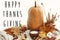 Happy Thanksgiving text on pumpkin, candle light, fall leaves, b