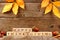 Happy Thanksgiving wooden blocks with wood background, acorns, leaves