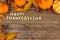 Happy Thanksgiving wooden letters with autumn corner border on wood