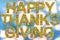 Happy Thanksgiving written with words made of leaves and blue